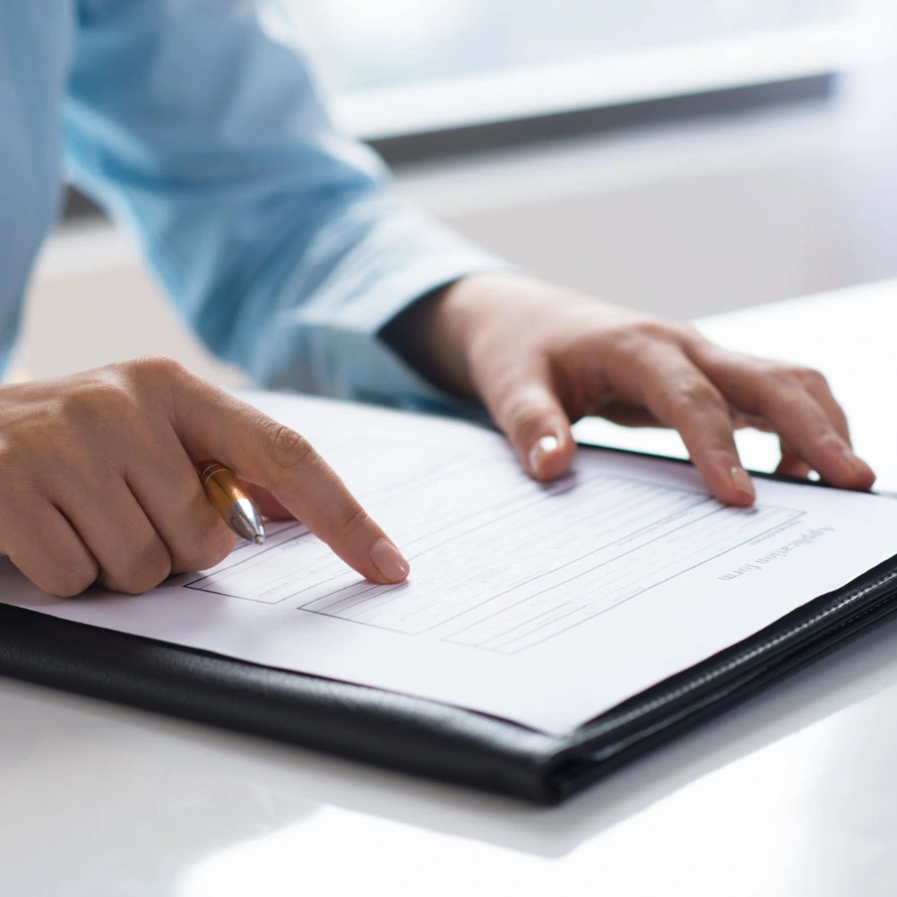 closeup-of-person-reading-and-studying-document-Q